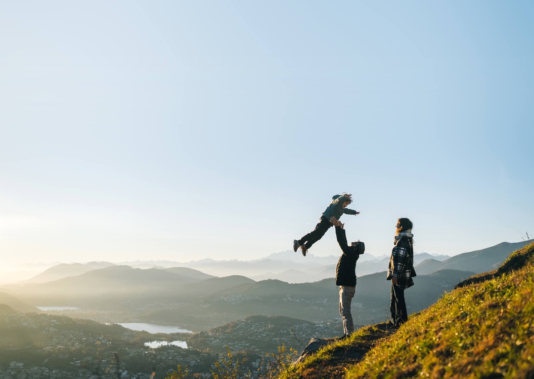Family walking through a mountain landscape at sunrise